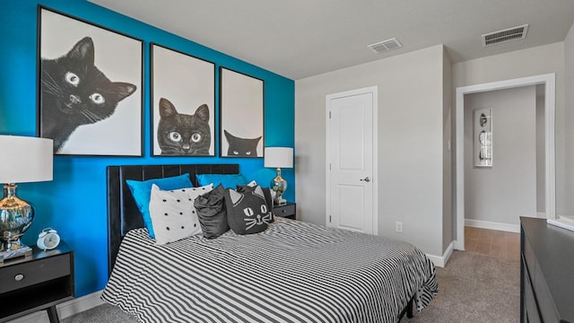 bedroom with carpet flooring, visible vents, and baseboards