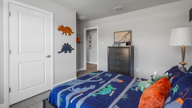 carpeted bedroom featuring visible vents and baseboards