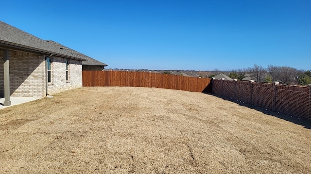 view of yard with a fenced backyard