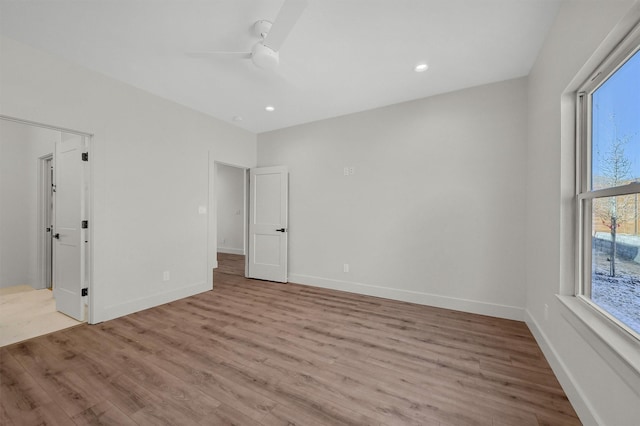 unfurnished bedroom featuring light wood-style floors, ceiling fan, baseboards, and recessed lighting