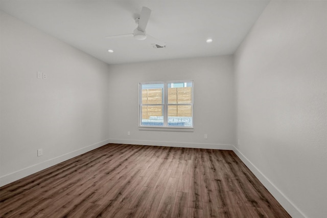 empty room featuring a ceiling fan, baseboards, and wood finished floors