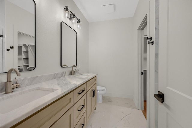 full bath with marble finish floor, a sink, baseboards, and double vanity