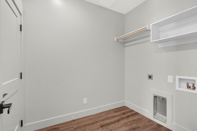 clothes washing area with washer hookup, electric dryer hookup, wood finished floors, laundry area, and baseboards