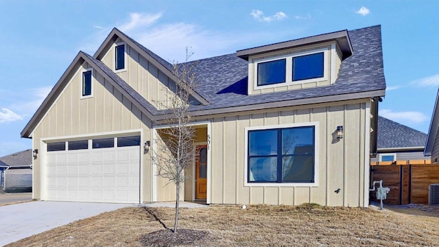 view of front of house featuring central air condition unit, a garage, a shingled roof, driveway, and board and batten siding