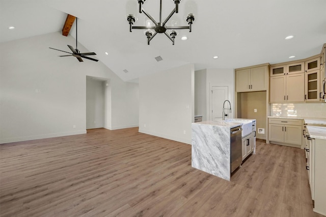 kitchen with glass insert cabinets, open floor plan, a center island with sink, and stainless steel dishwasher