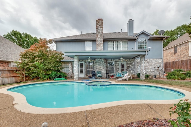 view of pool featuring a ceiling fan, a pool with connected hot tub, a patio area, and fence