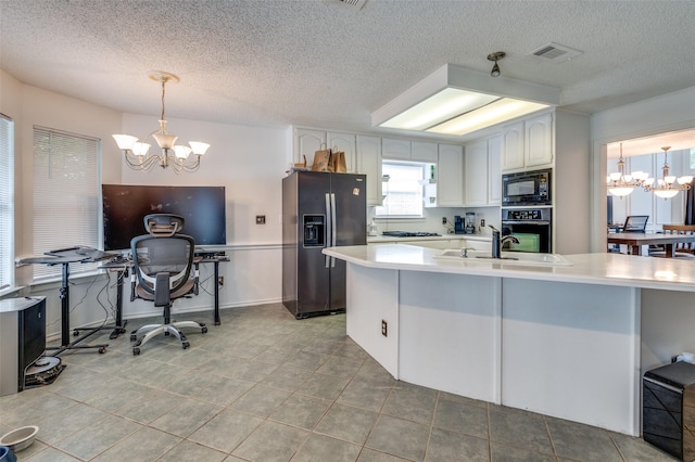 kitchen featuring black appliances, white cabinets, a notable chandelier, and light countertops