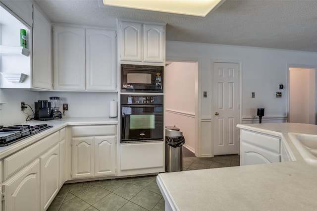 kitchen featuring white cabinets, black appliances, light countertops, and light tile patterned flooring