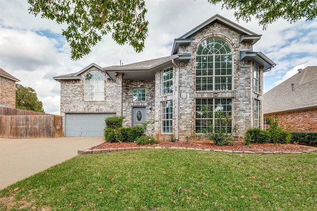 view of front of property with a garage, concrete driveway, a front yard, and fence