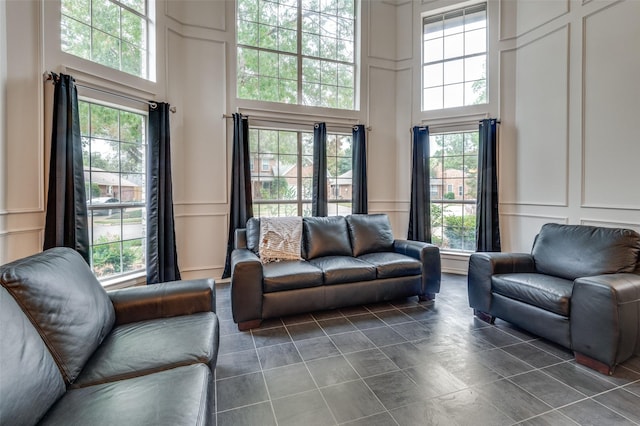 living room with a decorative wall and a towering ceiling