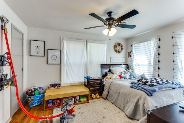 bedroom with ceiling fan and wood finished floors