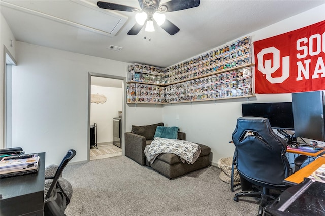 office area featuring carpet floors, visible vents, and ceiling fan