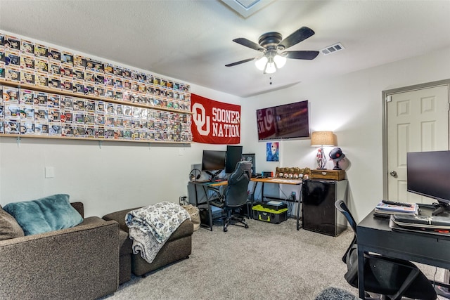 carpeted office with ceiling fan and visible vents