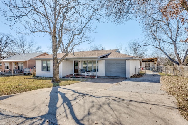 view of front of property with a porch, an attached garage, fence, driveway, and a front yard