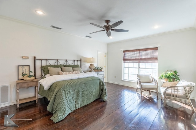 bedroom with dark wood-type flooring, visible vents, and ornamental molding