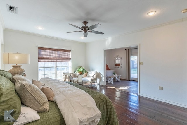 bedroom featuring visible vents, ornamental molding, dark wood-type flooring, ceiling fan, and baseboards