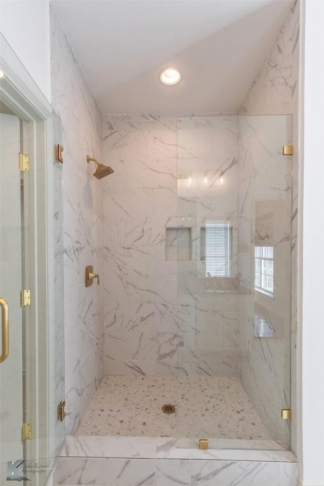 bathroom featuring recessed lighting and a marble finish shower