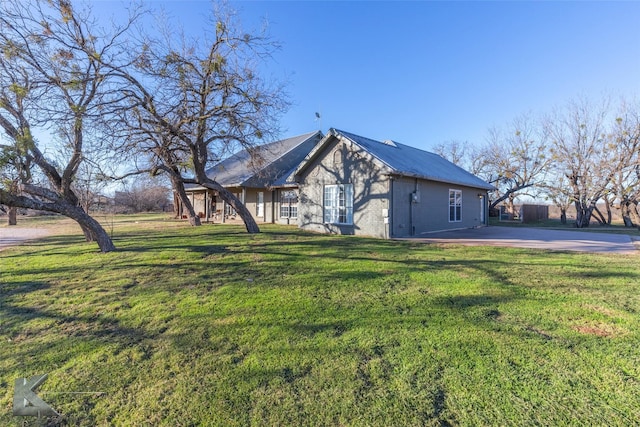 view of side of home featuring a yard