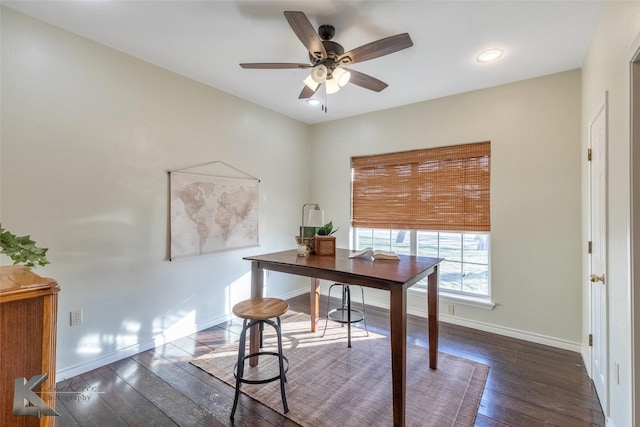 office space featuring dark wood-type flooring, baseboards, and a ceiling fan