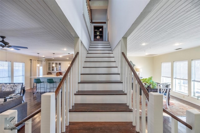 staircase with recessed lighting, ceiling fan, a wealth of natural light, and wood finished floors