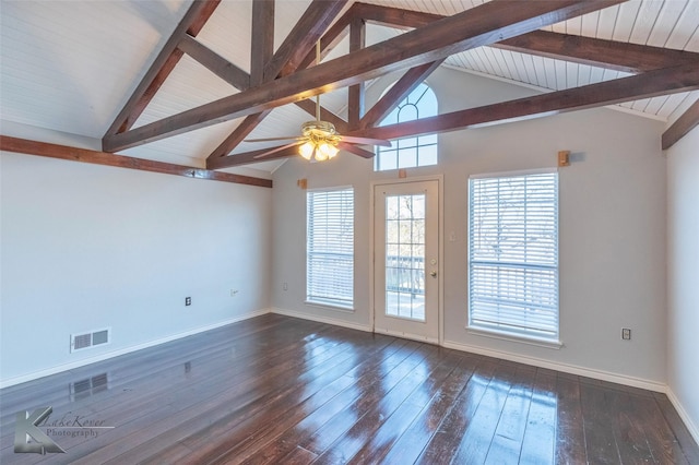 spare room featuring baseboards, visible vents, a ceiling fan, lofted ceiling with beams, and dark wood-style floors