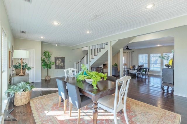 dining area featuring dark wood-type flooring, recessed lighting, visible vents, and stairway