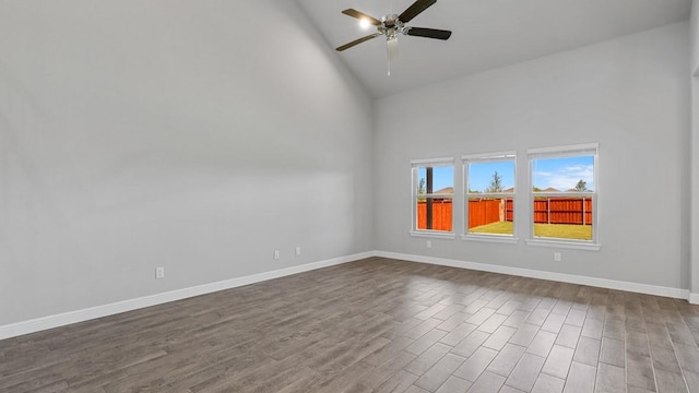 unfurnished room featuring high vaulted ceiling, ceiling fan, baseboards, and wood finished floors