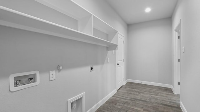 washroom with hookup for an electric dryer, laundry area, washer hookup, wood finished floors, and baseboards