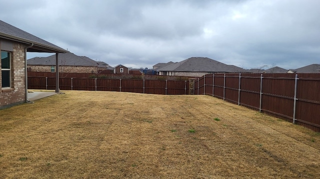 view of yard with a residential view and a fenced backyard