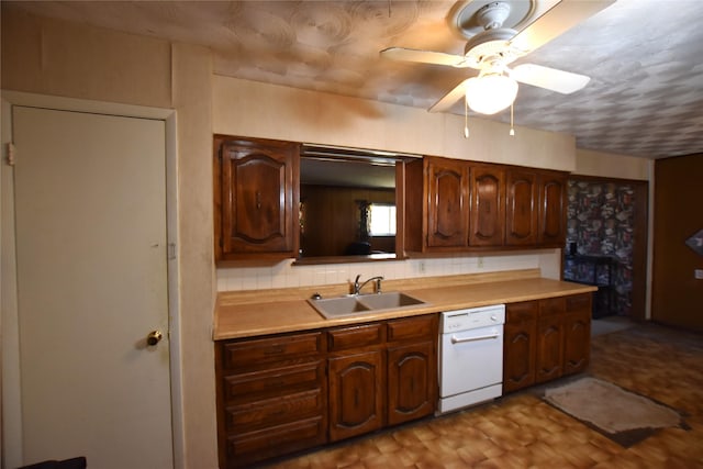 kitchen featuring decorative backsplash, dishwasher, ceiling fan, light countertops, and a sink