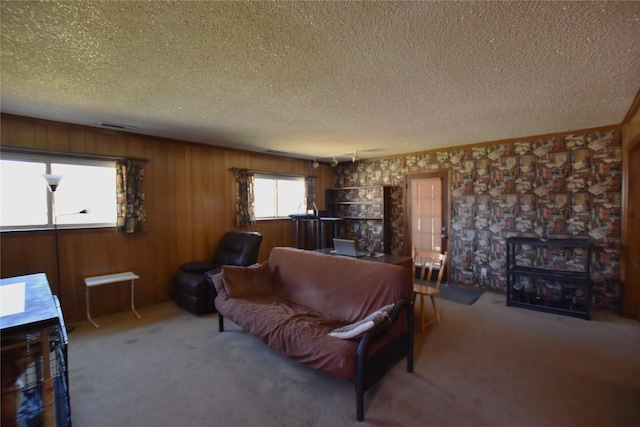 carpeted living area featuring visible vents and a textured ceiling