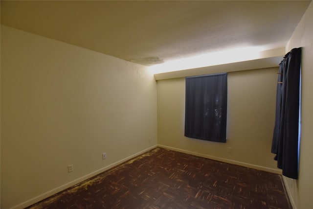 empty room with baseboards