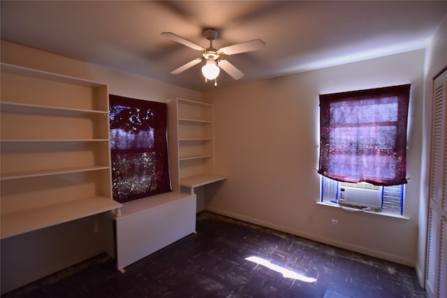 interior space featuring a ceiling fan, baseboards, and cooling unit