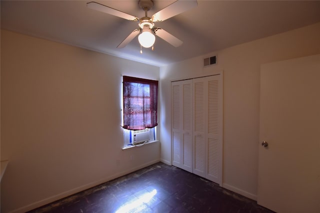 unfurnished bedroom with a ceiling fan, a closet, visible vents, and baseboards