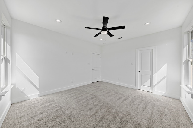 empty room featuring baseboards, visible vents, light colored carpet, ceiling fan, and recessed lighting