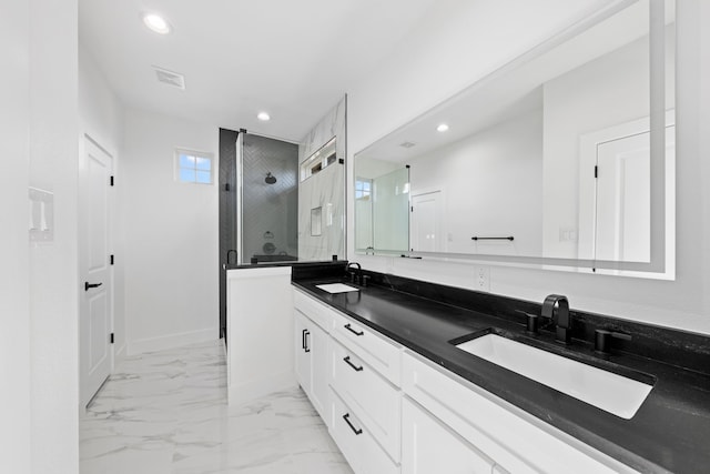 bathroom featuring marble finish floor, recessed lighting, a sink, and a stall shower