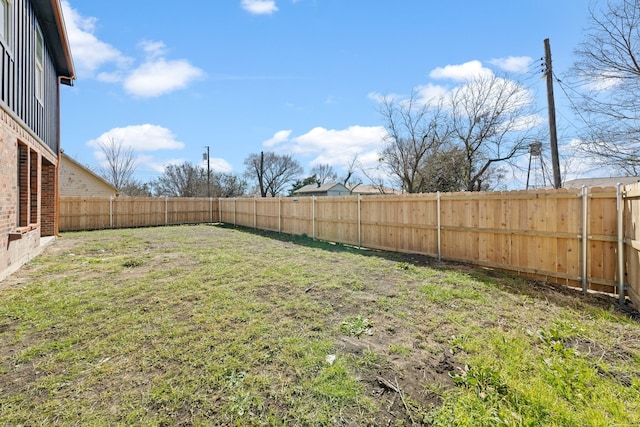 view of yard with a fenced backyard