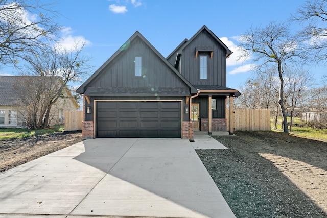 view of front facade featuring driveway, fence, and brick siding