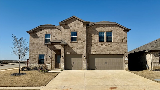 traditional-style home with a garage, concrete driveway, and brick siding