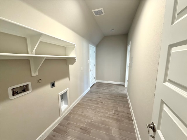 laundry area with hookup for a washing machine, laundry area, wood finish floors, baseboards, and electric dryer hookup