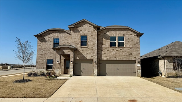 view of front of house with a garage, driveway, and brick siding