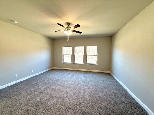 carpeted spare room featuring a ceiling fan, a textured ceiling, and baseboards