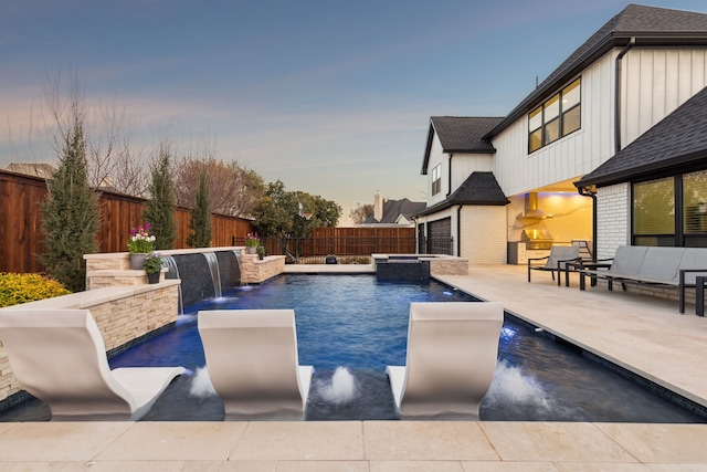 view of pool featuring a patio area, a fenced backyard, and a pool with connected hot tub