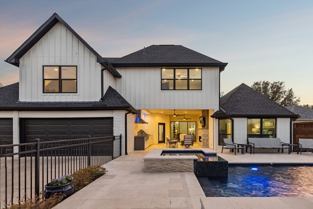 rear view of property featuring an outdoor living space with a fire pit, brick siding, roof with shingles, and fence