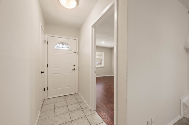 entryway featuring light tile patterned floors and baseboards