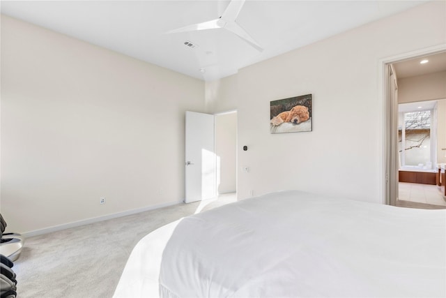 bedroom featuring light colored carpet, visible vents, ensuite bathroom, ceiling fan, and baseboards