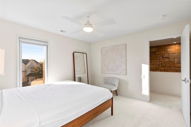 bedroom featuring visible vents, a ceiling fan, and light colored carpet