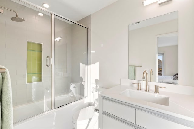 full bath featuring visible vents, toilet, enclosed tub / shower combo, vanity, and ensuite bath