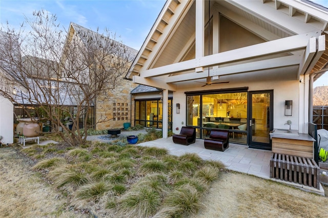 back of property featuring ceiling fan, a patio, and stucco siding