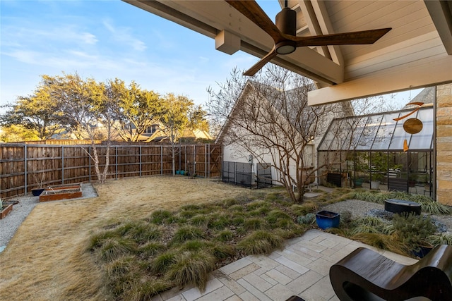 view of yard featuring a patio, a fenced backyard, and a ceiling fan